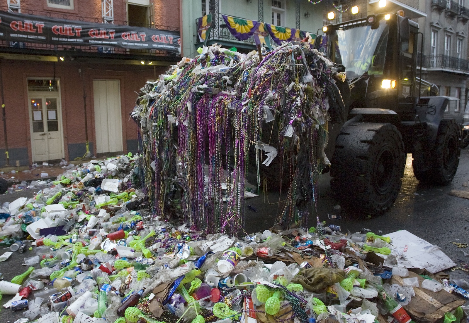 A front end loader removes trash and beads left on Bourbon Street after Mardi Gras in 2009