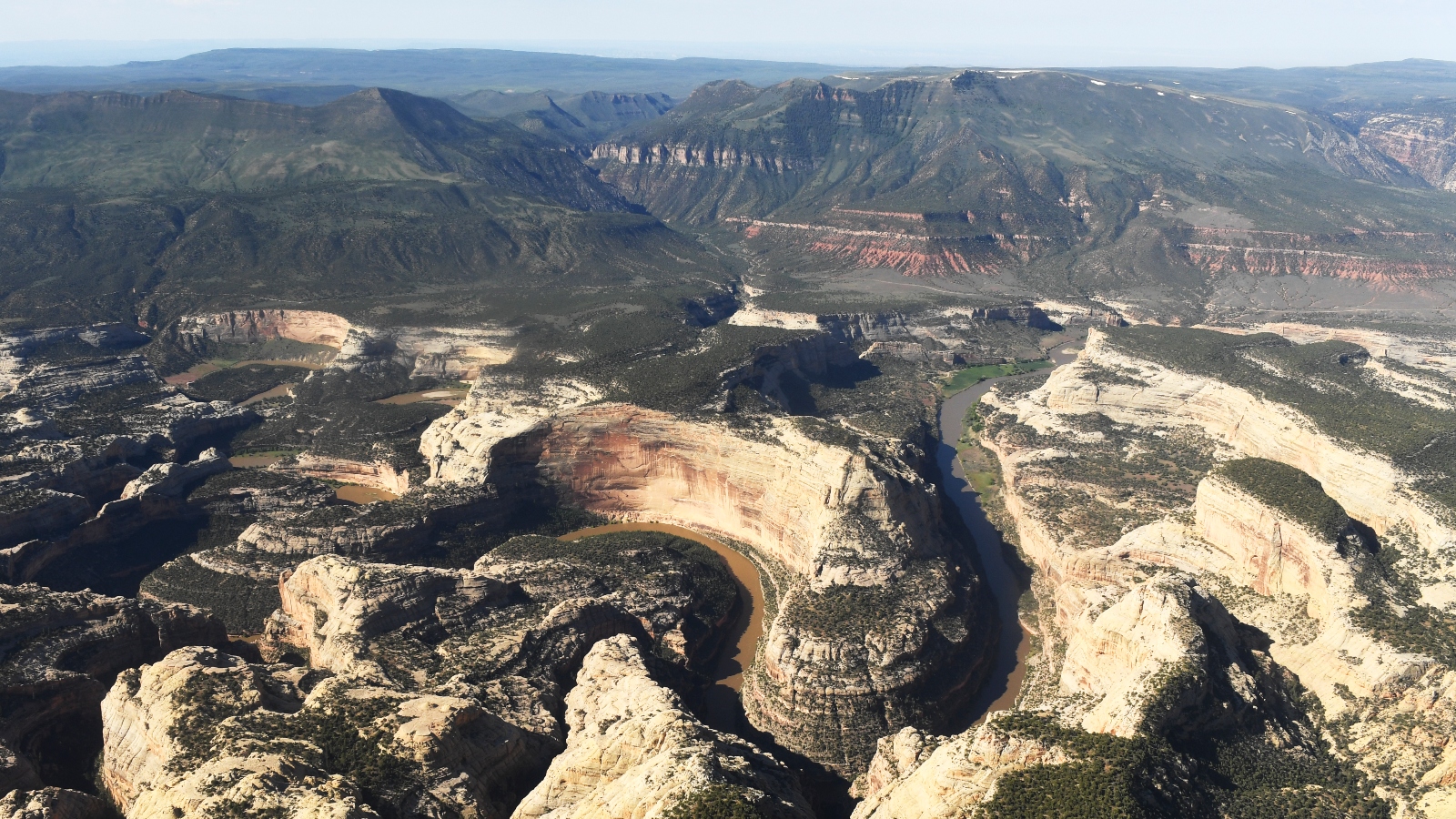 An aerial view of rolling mountains and canyons