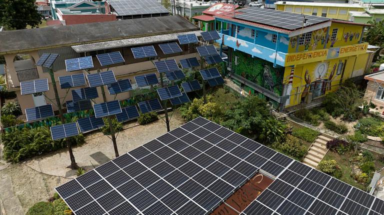 Aerial view of multiple solar panels on rooftops