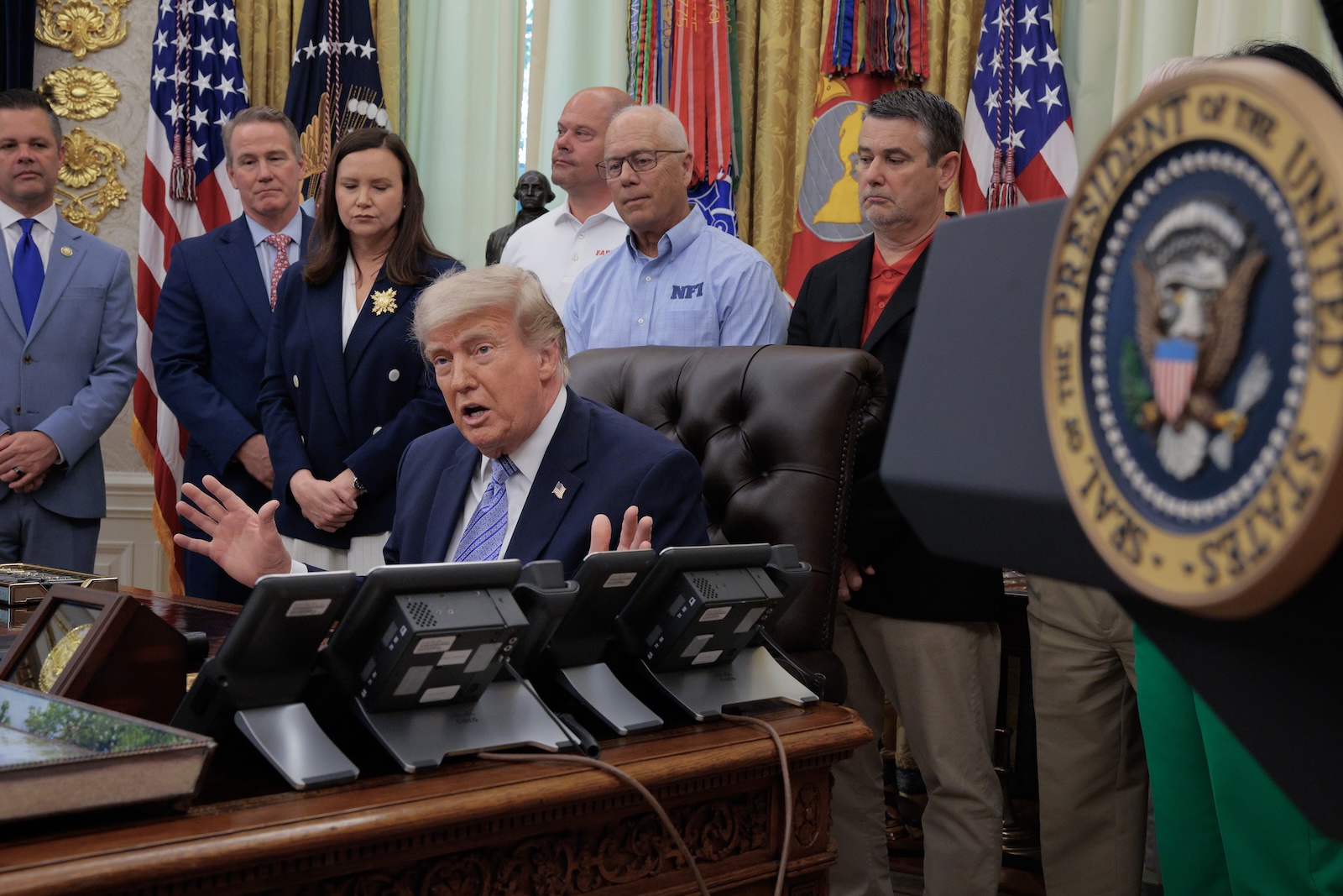 U.S. President Donald Trump is joined by grocery store owners and supermarket in the Oval Office