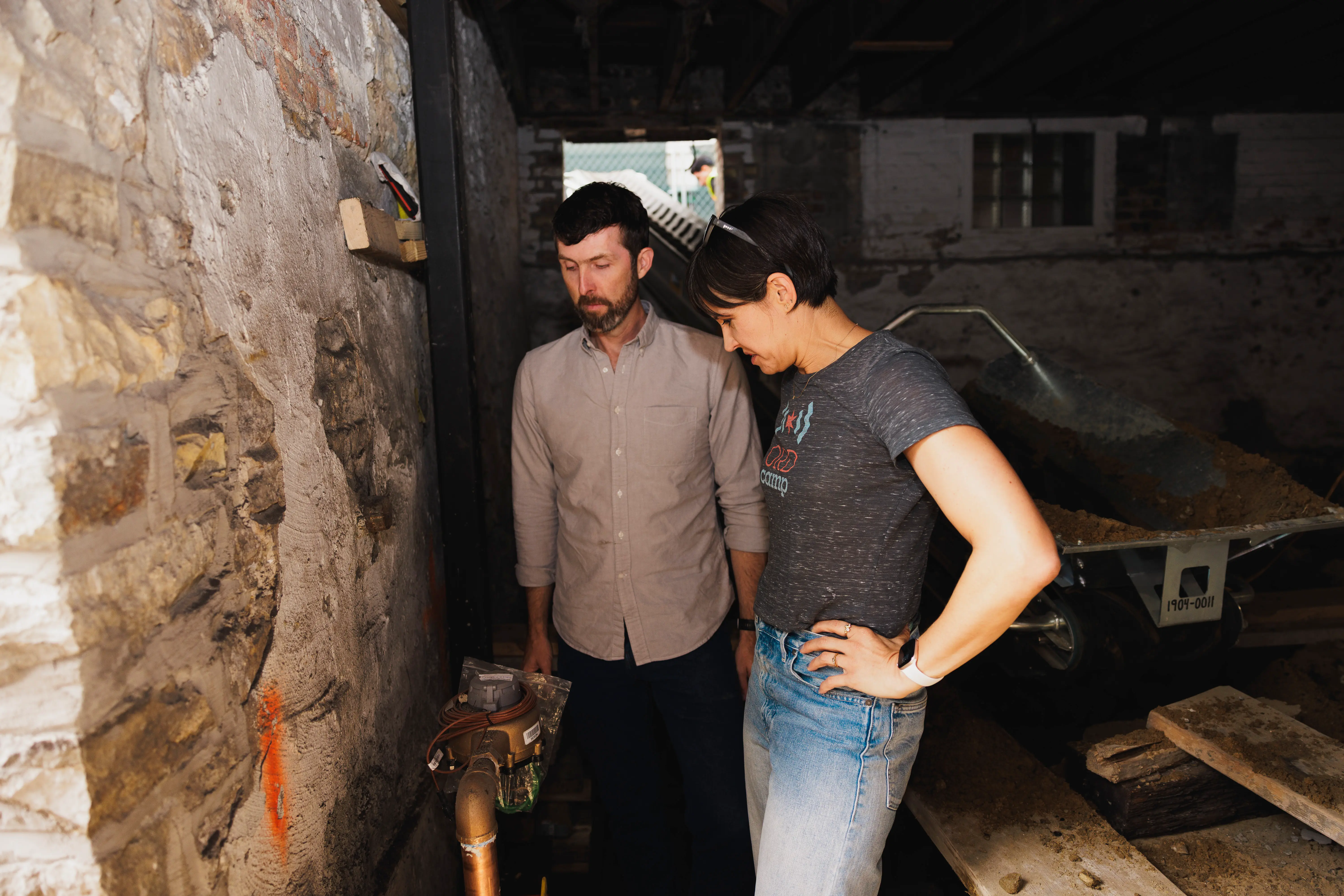 man and woman examine water meter