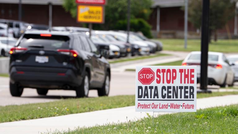 A home displays a “Stop the Date Center” sign along South 11th Street on Tuesday, May 19, 2026 in Nebraska City.