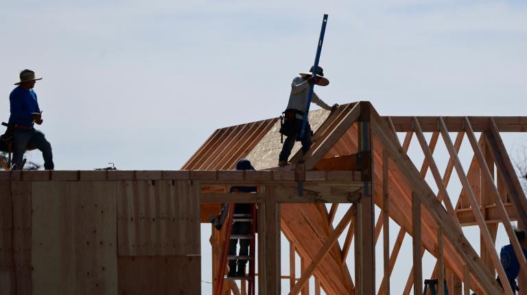 Construction workers rebuild a home in Altadena, California, one year after the Eaton Fire. California has been waiting for supplemental housing aid from the federal government.