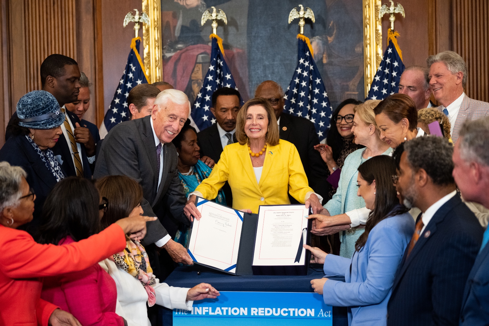 Then-Speaker of the House Nancy Pelosi and other Democratic lawmakers hold up the Inflation Reduction Act during a signing ceremony at the Capitol in August 2022. The bill was the largest climate investment in US history.