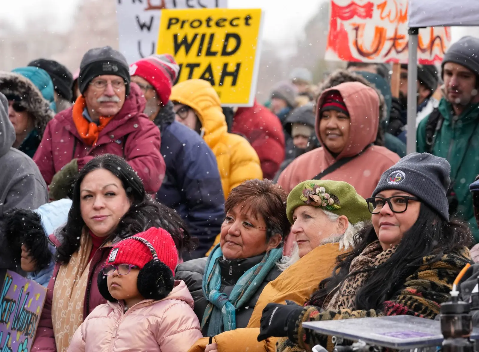 Politicians and tribal members are among the people attending a rally as snowflakes fall