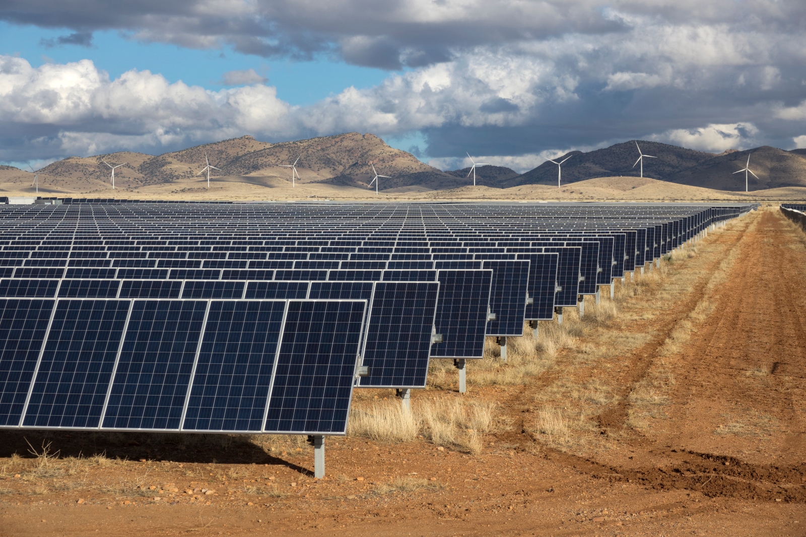Solar panels and wind turbines in southern Arizona generate electricity for the city of Tucson. Both solar and wind have seen continued investment despite the repeal of the Inflation Reduction Act.