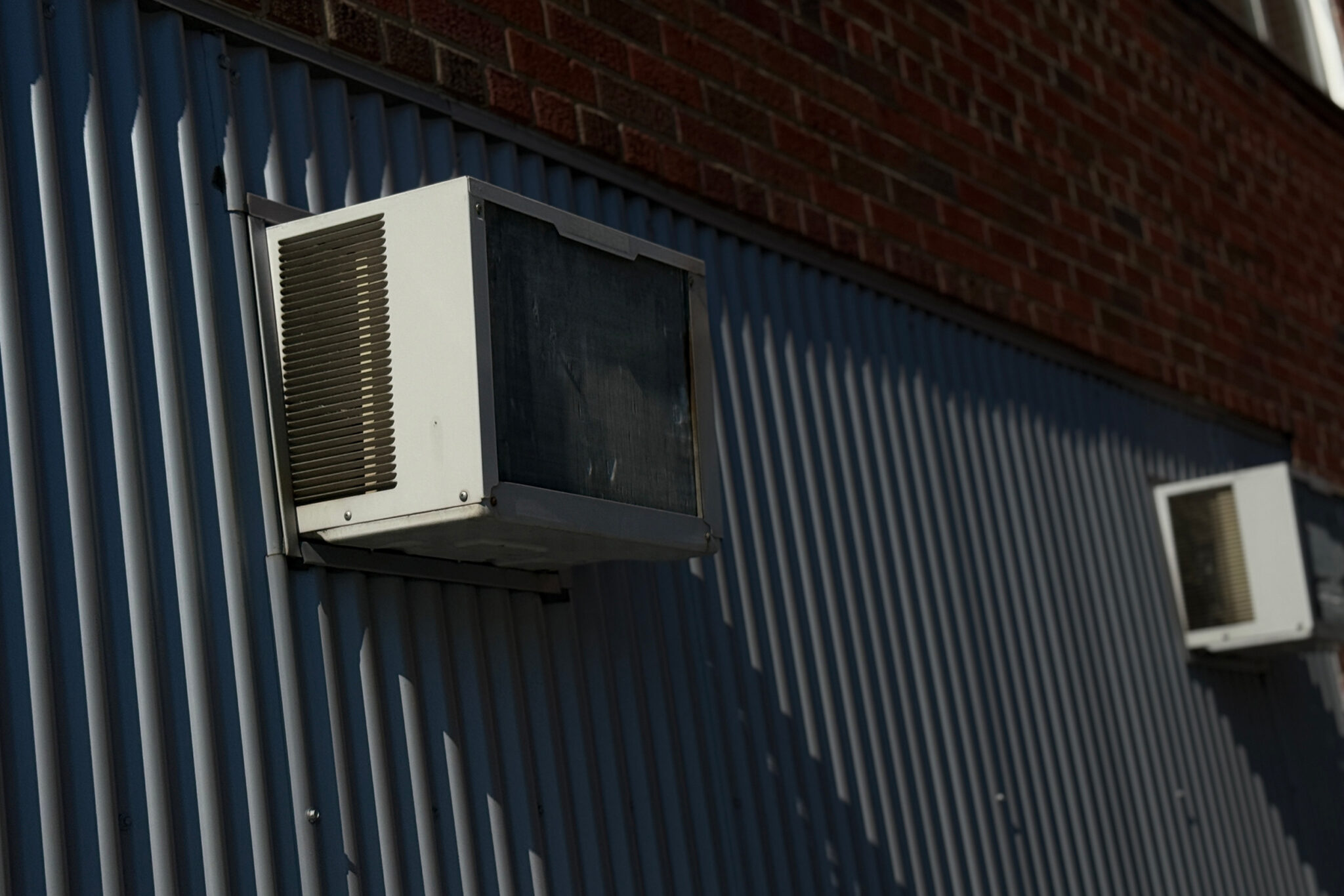 Two AC units on a wall