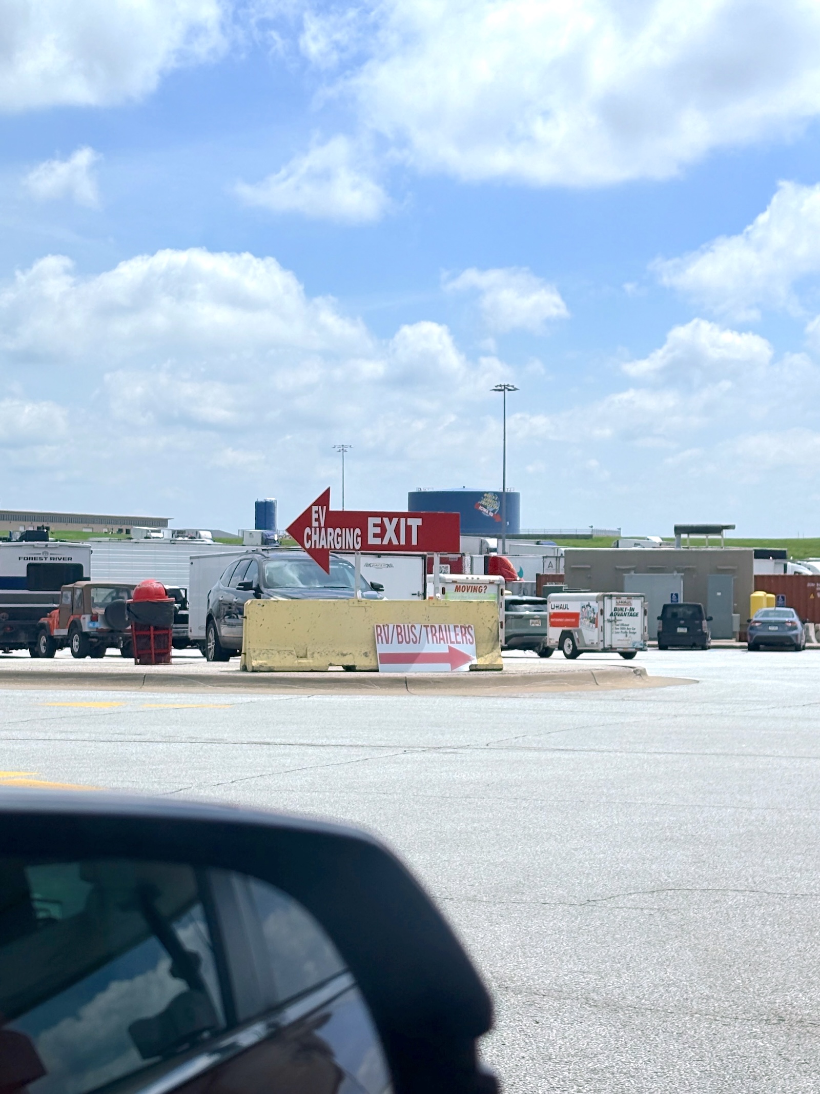 A sign for an EV charging station at a large truck stop