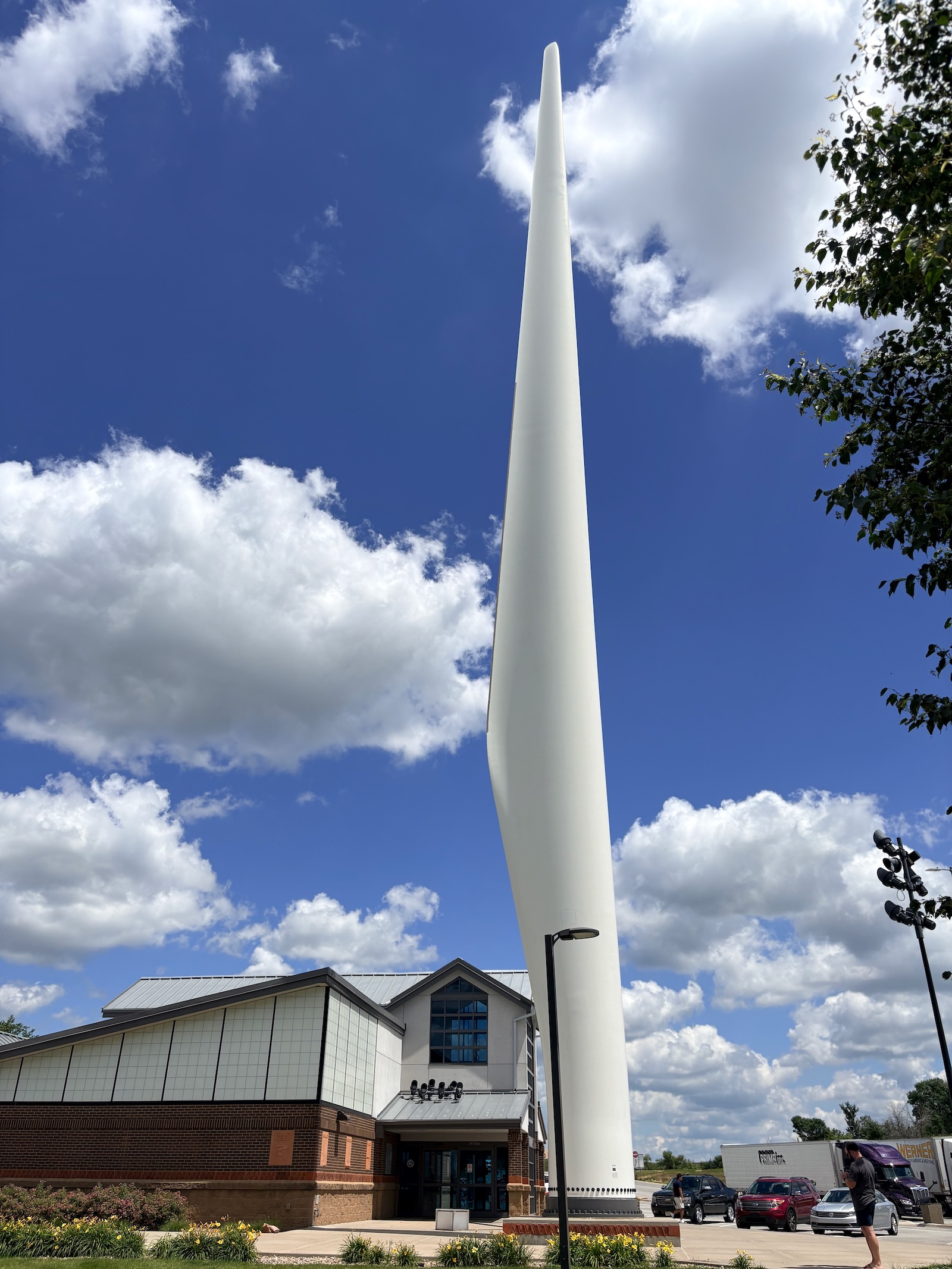 a tall white wind turbine