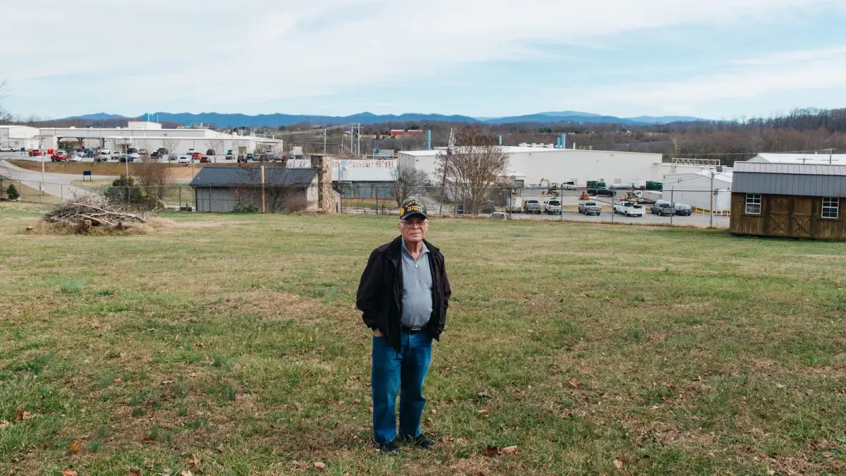 A man out standing in his field.