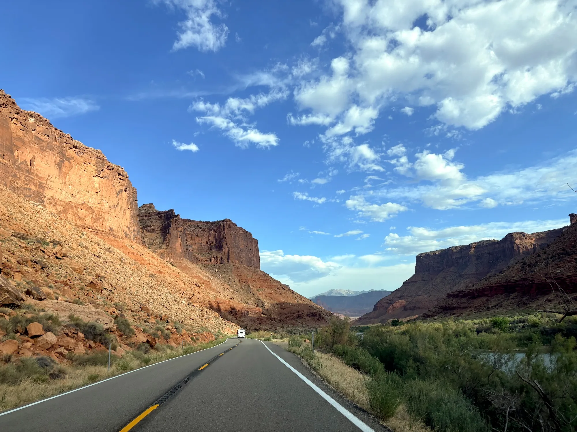 A desert highway with a big blue sky overhead