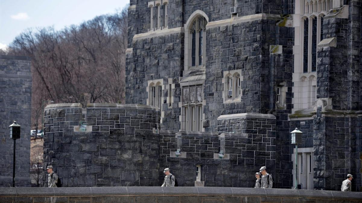 Cadets are seen at a Gothic looking building