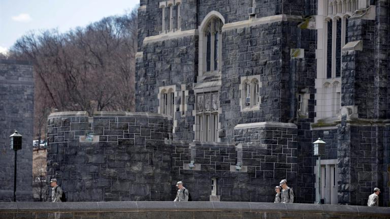 Cadets are seen at a Gothic looking building