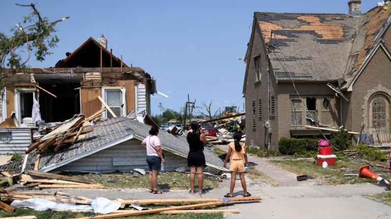 Residents inspect the damage amid debris and destroyed homes a day after a tornado ripped through Menasha, Wisconsin, on July 28, 2026.