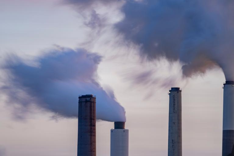 Exhaust blows out of flue-gas stacks, which you can just see the tops of
