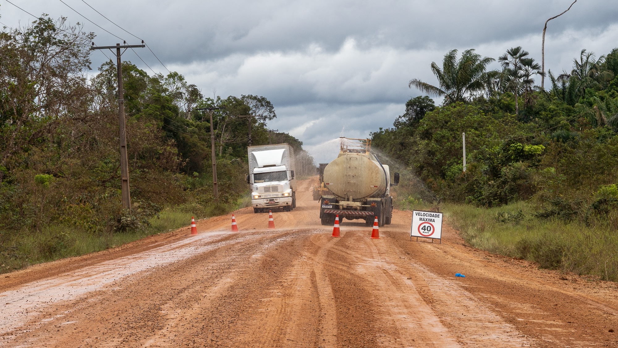 a road crew paving in the amazon rainforest