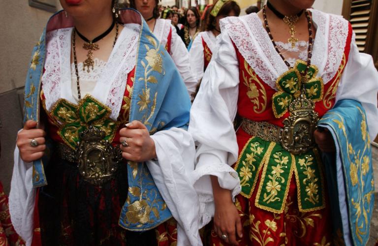 Women in traditional Albanian Italian costumes walk through the streets on Easter in Sicily
