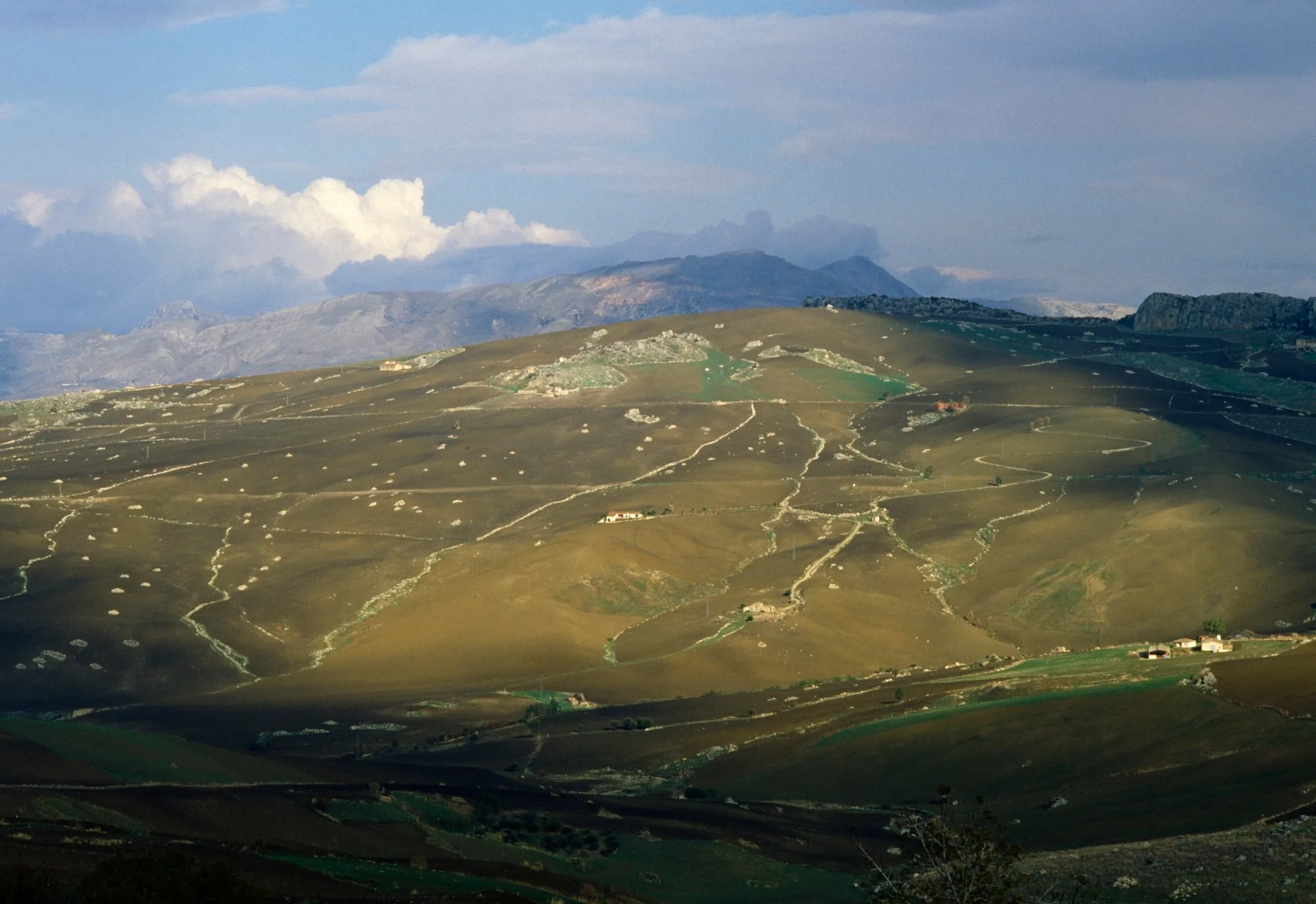 clouds and farms of a picturesque hillside
