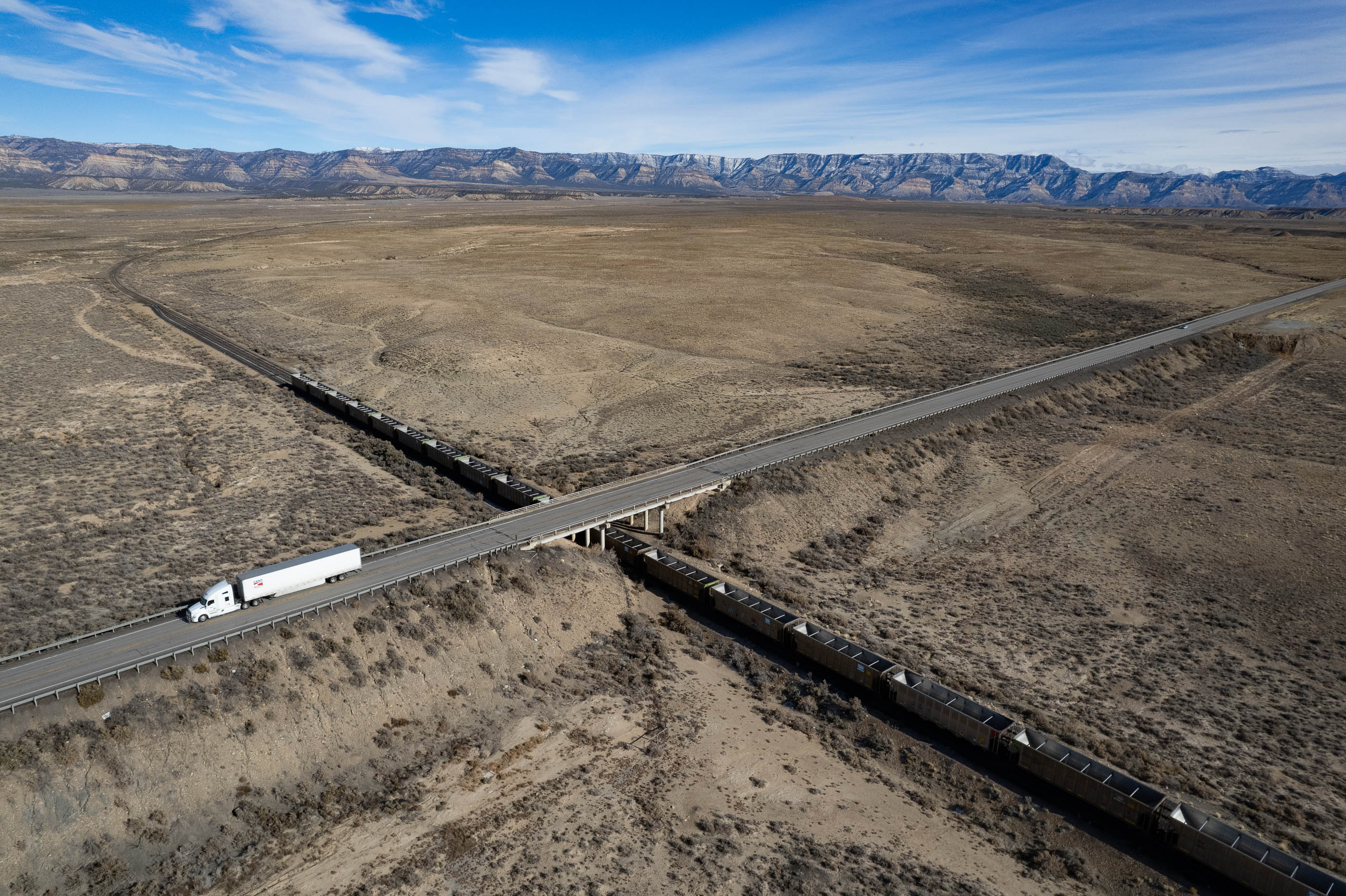 Empty coal cars sit idle against a barren landscape in Carbon County, Utah.