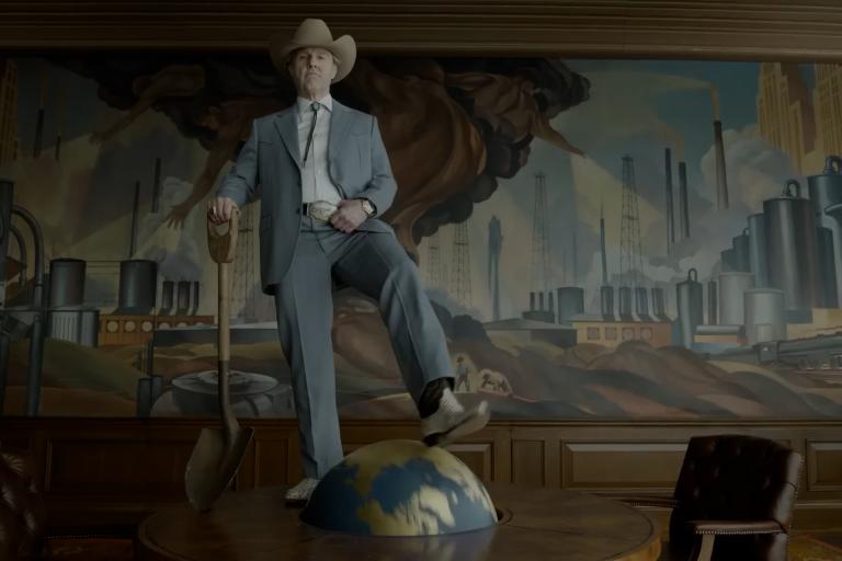 An image from the movie Digger showing Tom Cruise's character addressing a government assembly