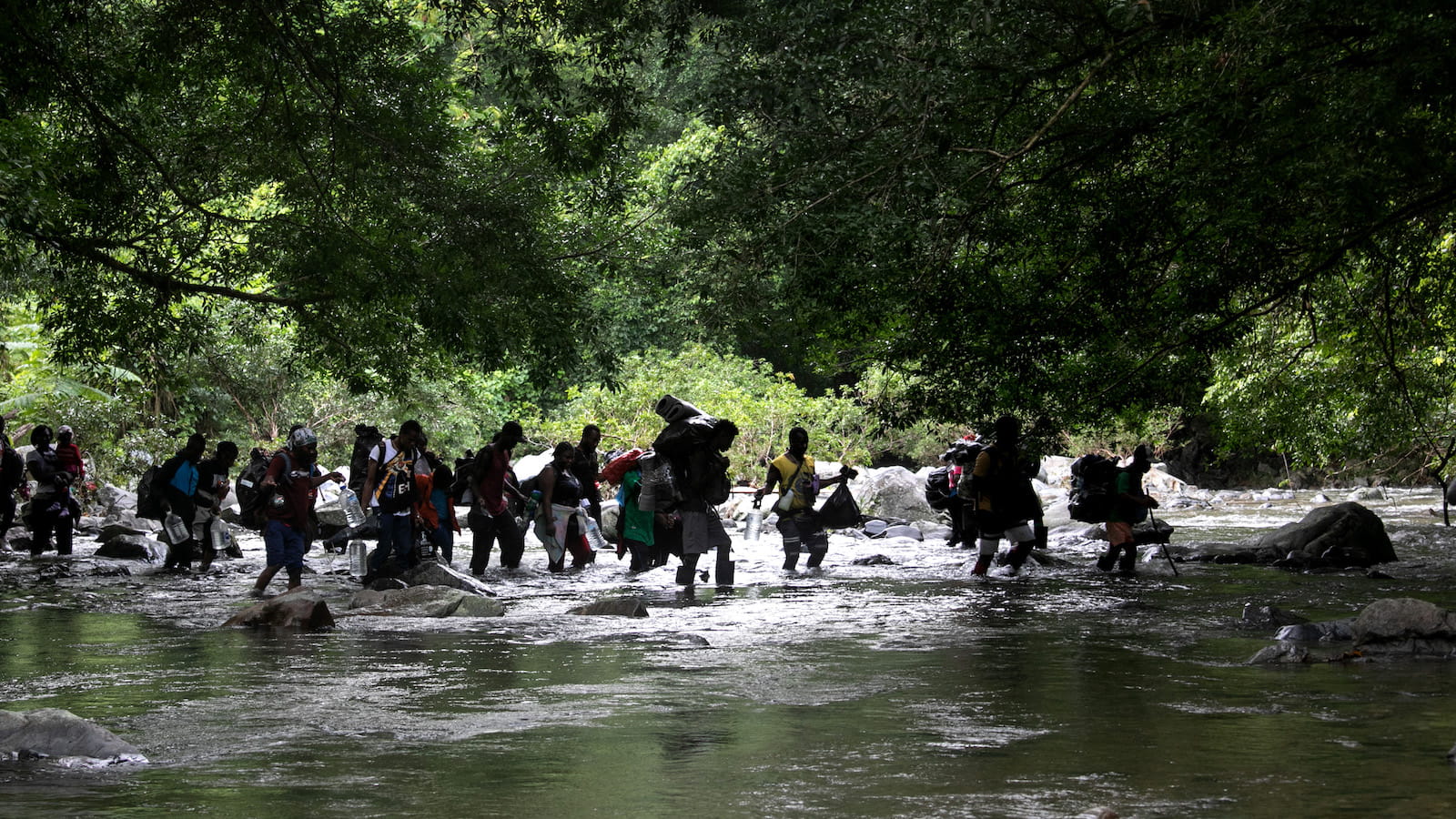 Several people seen crossing a river