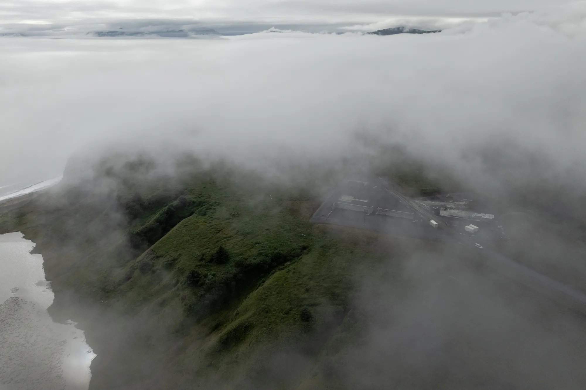 An aeral view of kodiak island with clouds and a view of a construction area