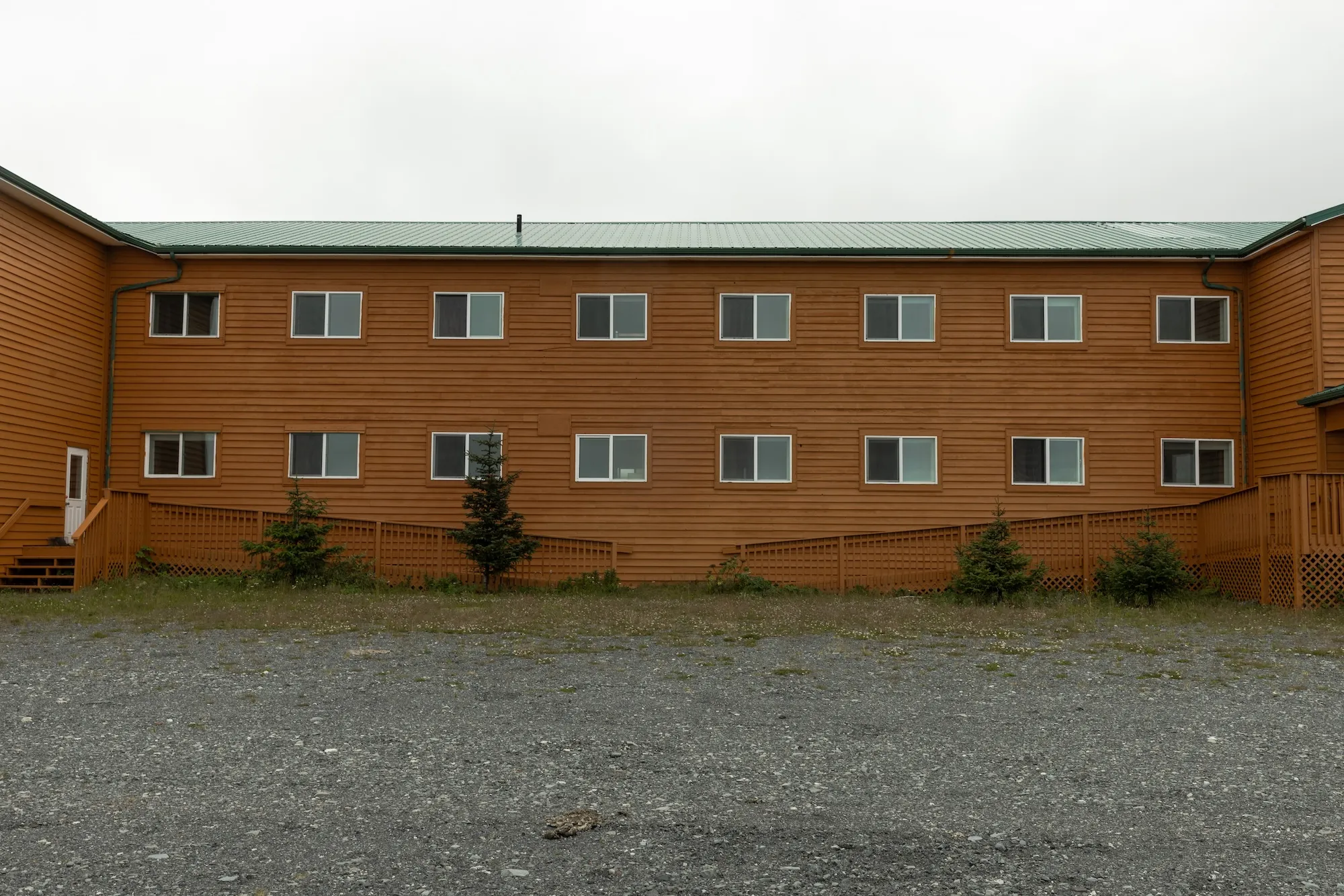 a building made of red stone with many windows and a large courtyard