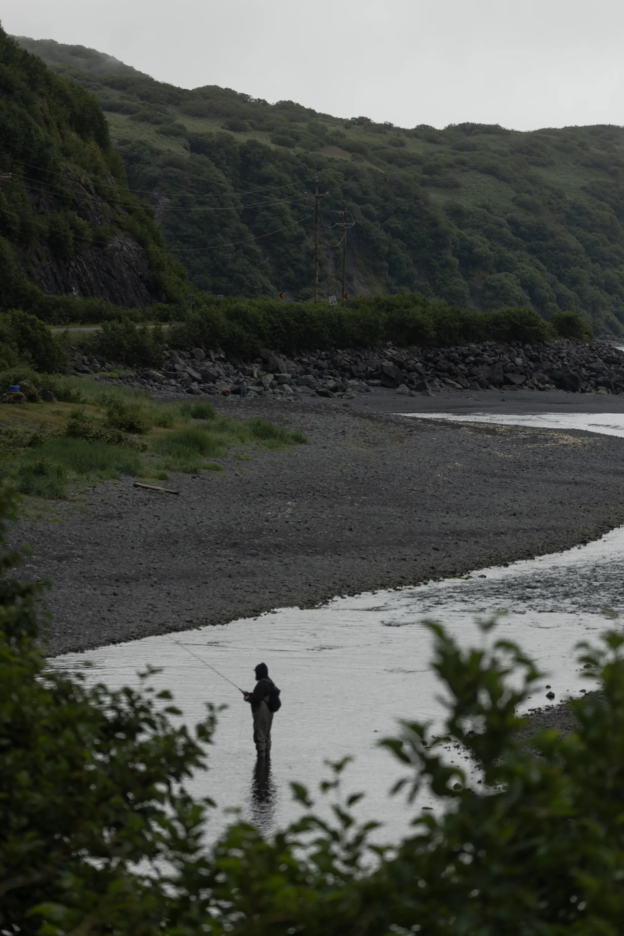 A man fishes in a river