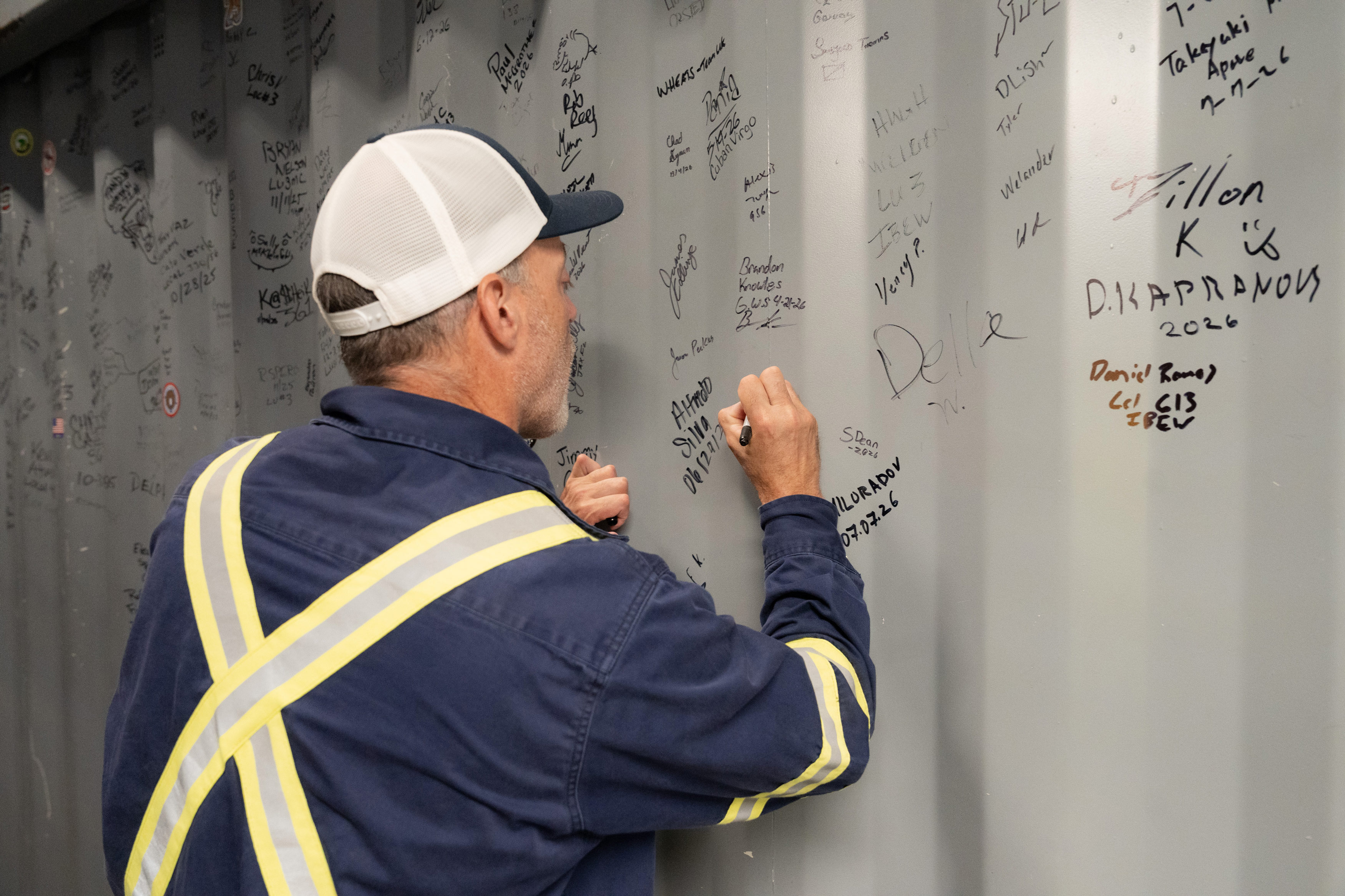 A man writes on a wall