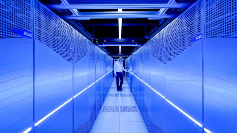 A blue corridor with a man in the middle