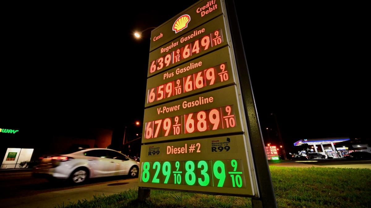A motorist pulls into a gas station where the marque lists gas prices that include diesel fuel for eight dollars and twenty-nine cents a gallon.