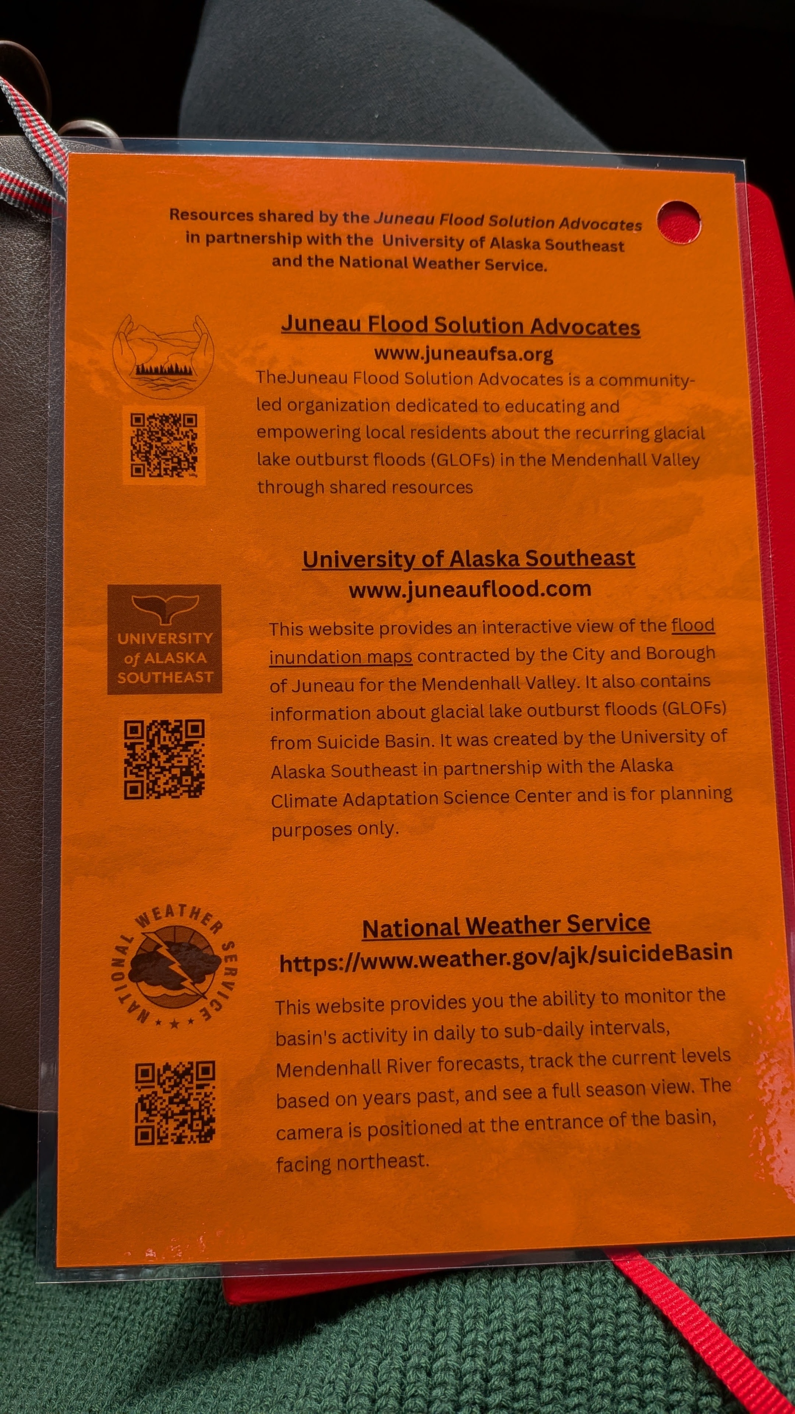 An orange flyer with a QR code and other written information