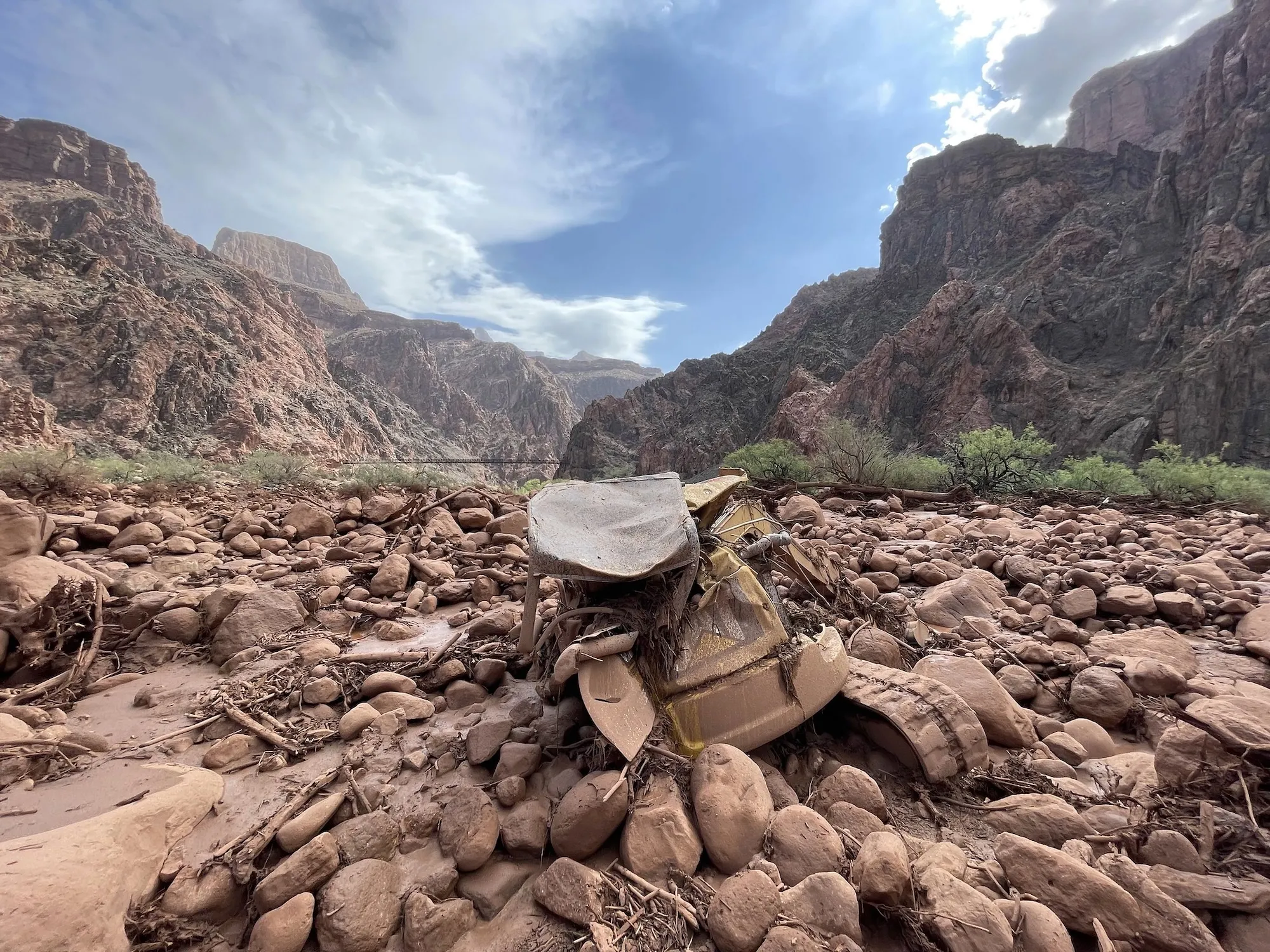 a vehicle covered in mud in the middle of the grand canyon