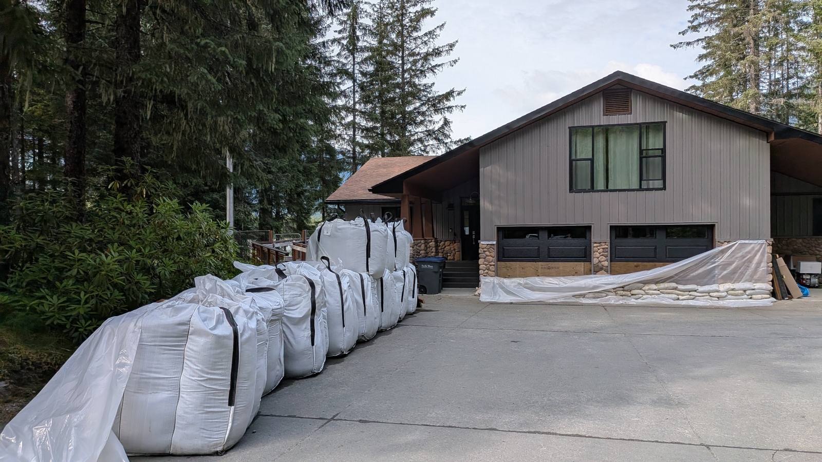 Sandbags line a driveway to a residential home
