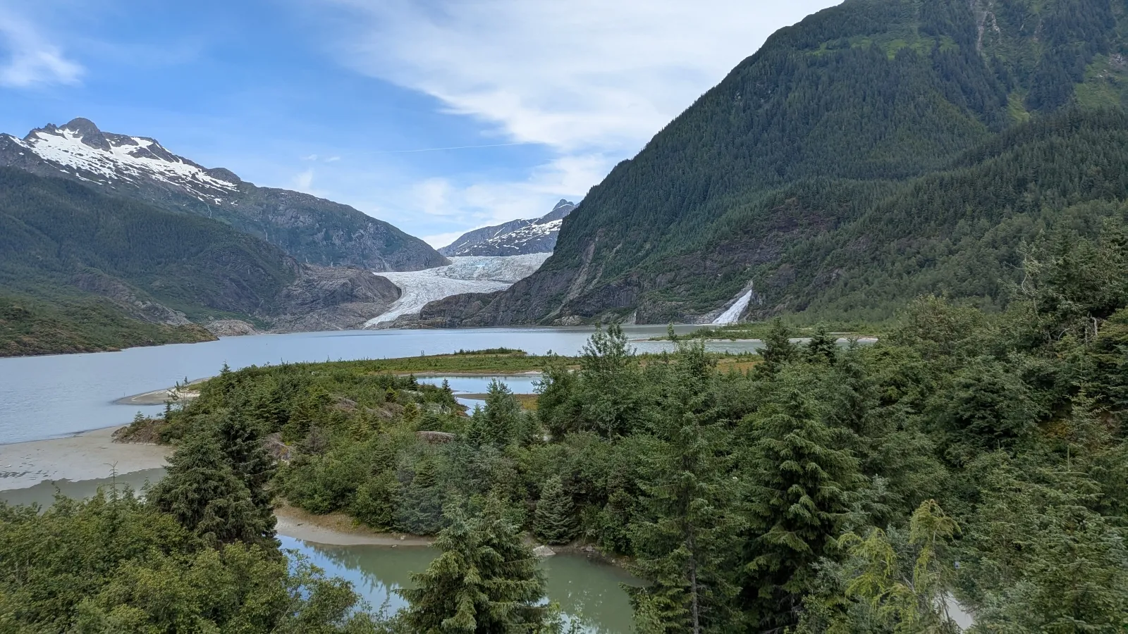 The Mendenhall Glacier is seen looming behind a residential neighborhood
