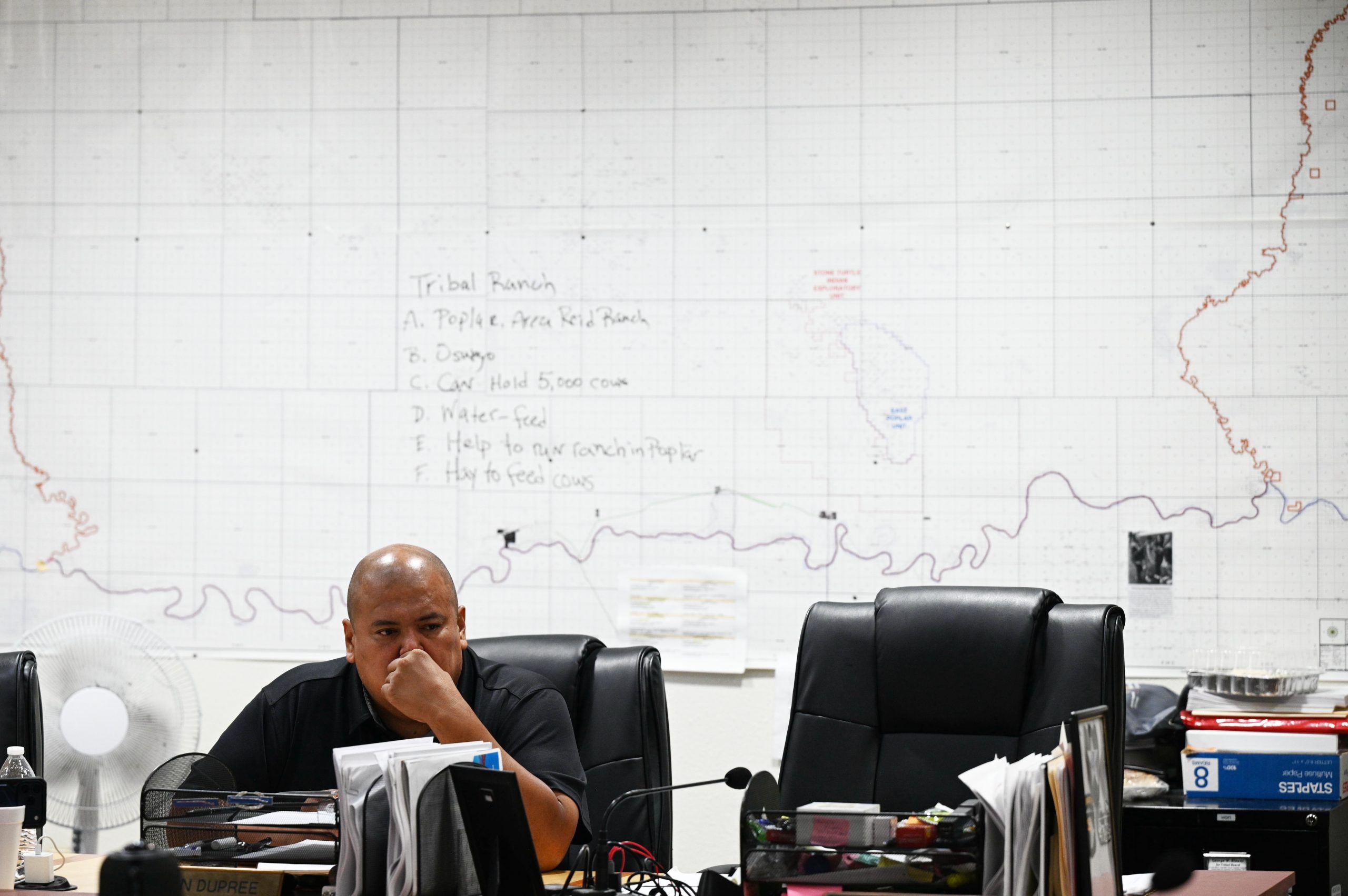 Jestin Dupree sitting at a desk with a map on the wall behind him