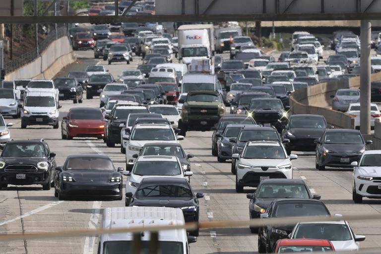 Cars stream down a highway