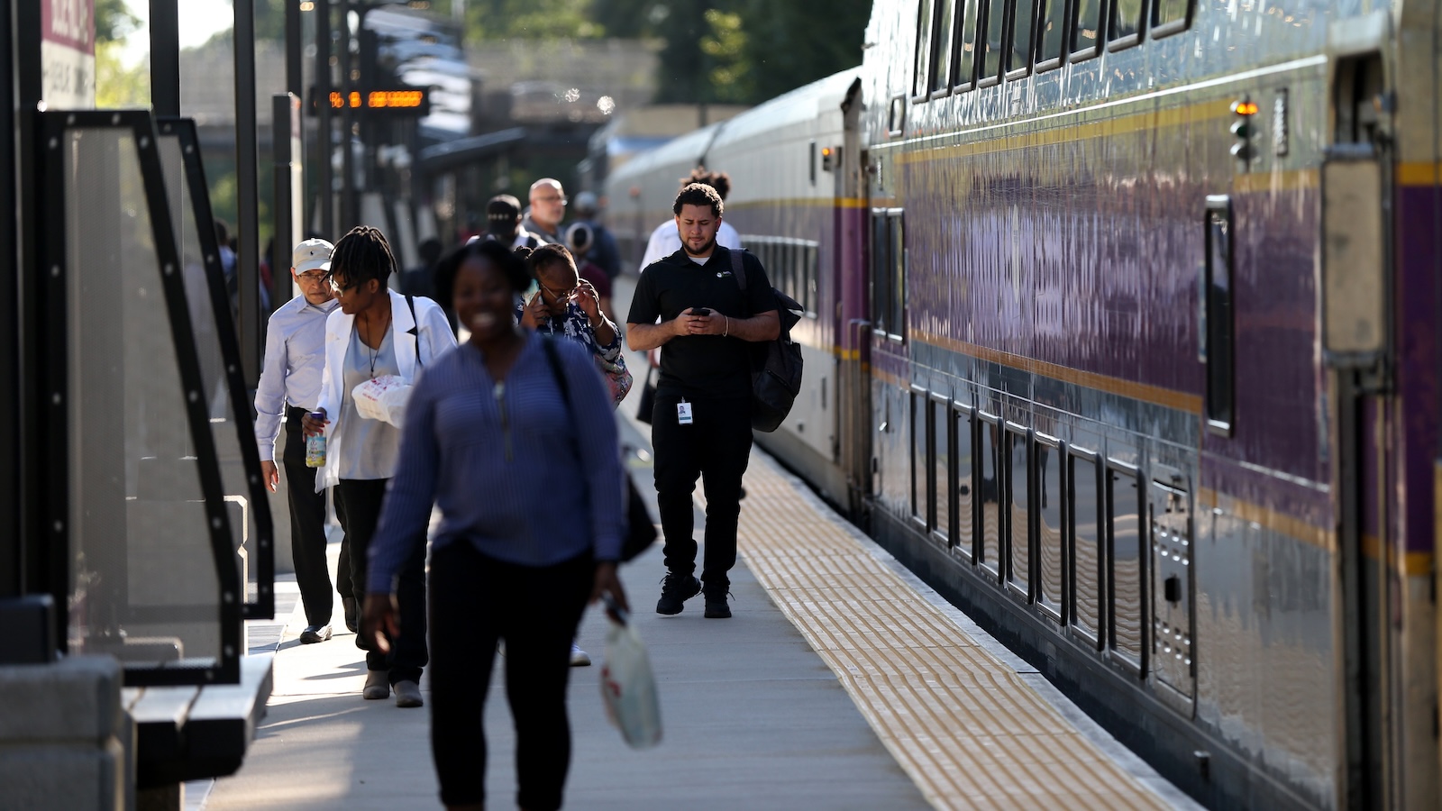 Commuters exit a train in Boston.