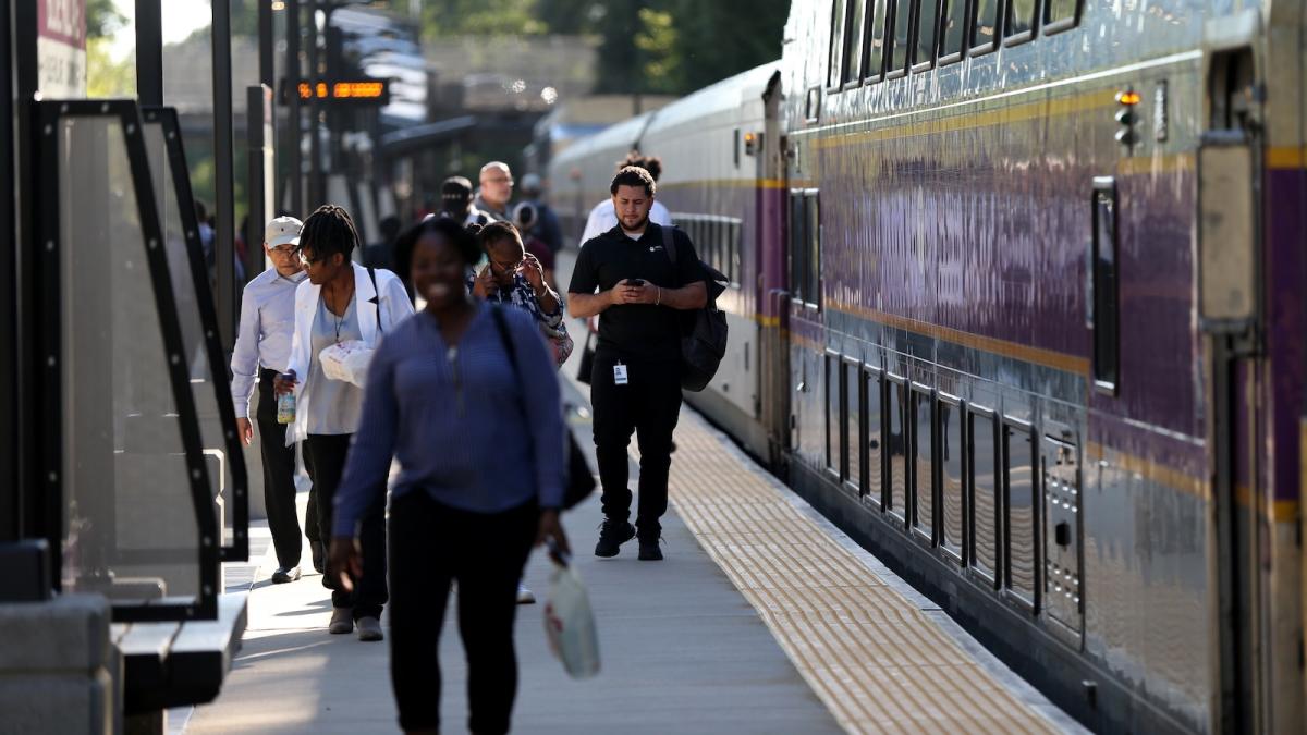 Commuters exit a train in Boston.