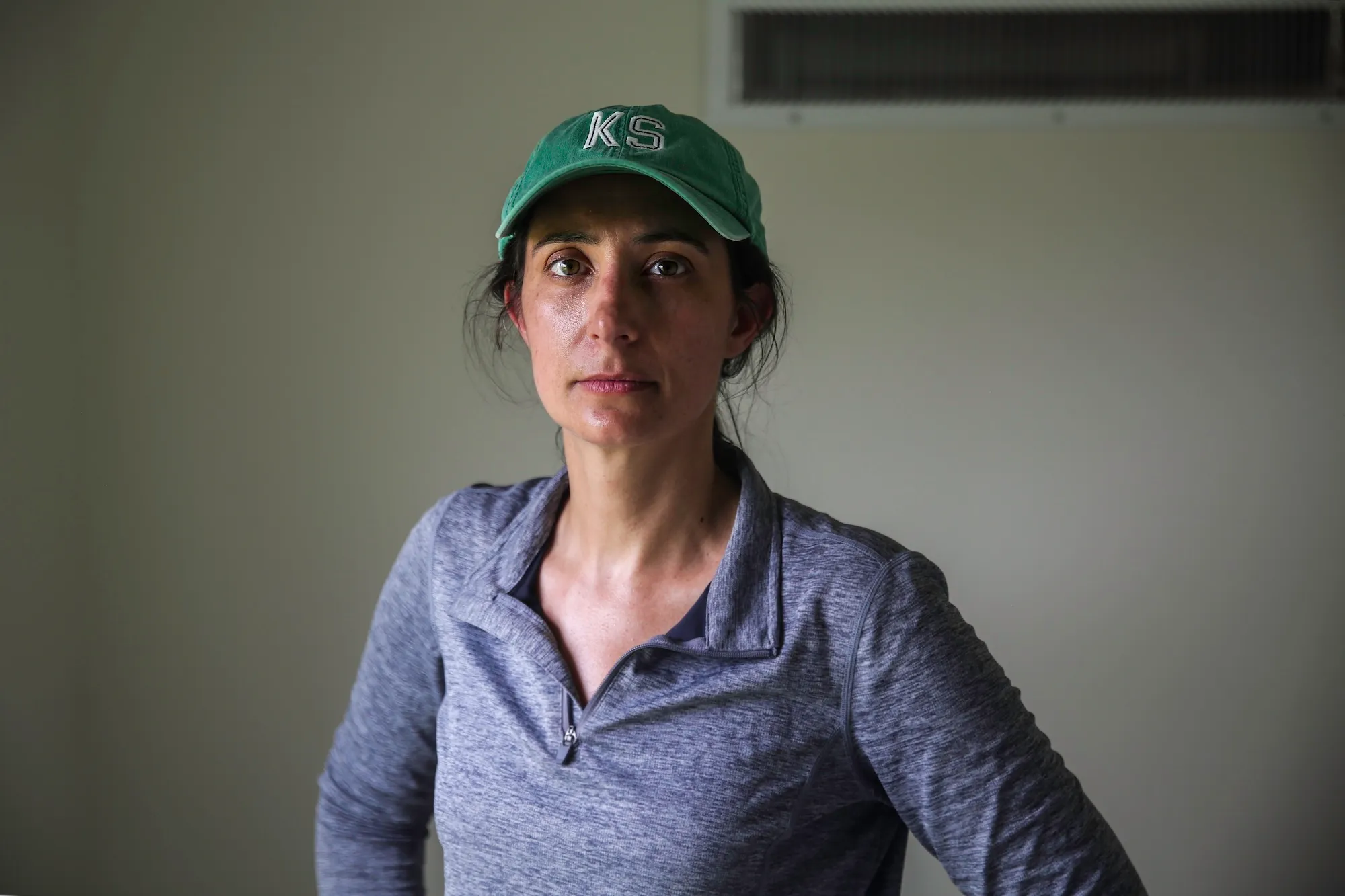 A woman in a green baseball cap