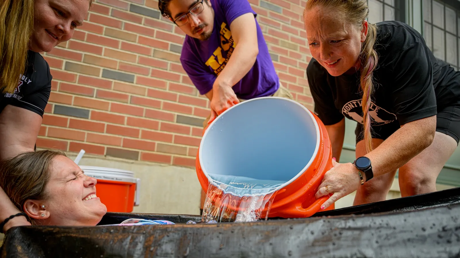 High school athletic trainers in Norwich, Connecticut, douse a colleague in ice water during a training exercise meant to help them protect players from extreme heat.