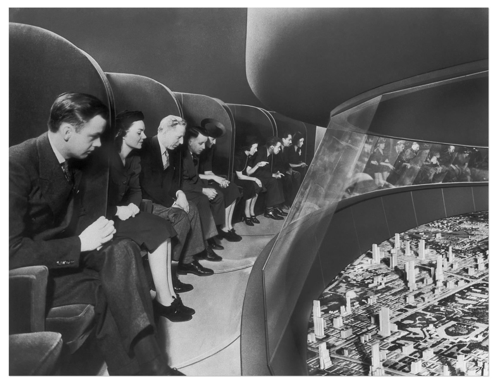 Photo of people peering over at a futuristic model city below