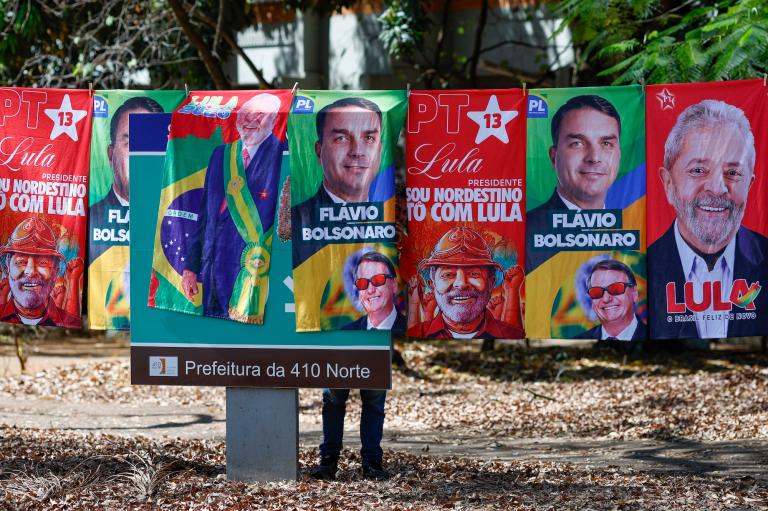 towels with images of the two Brazilian presidential candidates hang near a sign