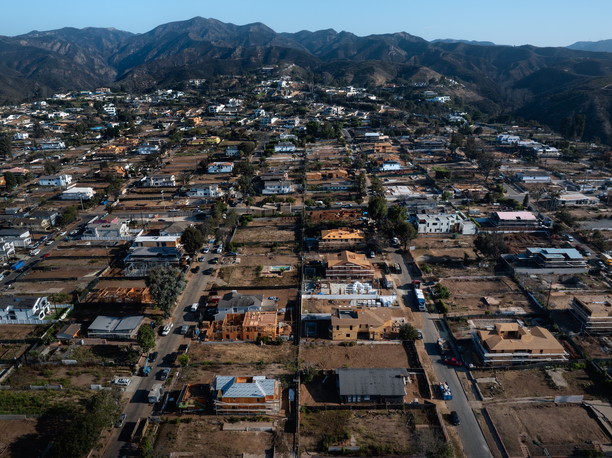 An aerial view of burned and partially reubuilt houses in California